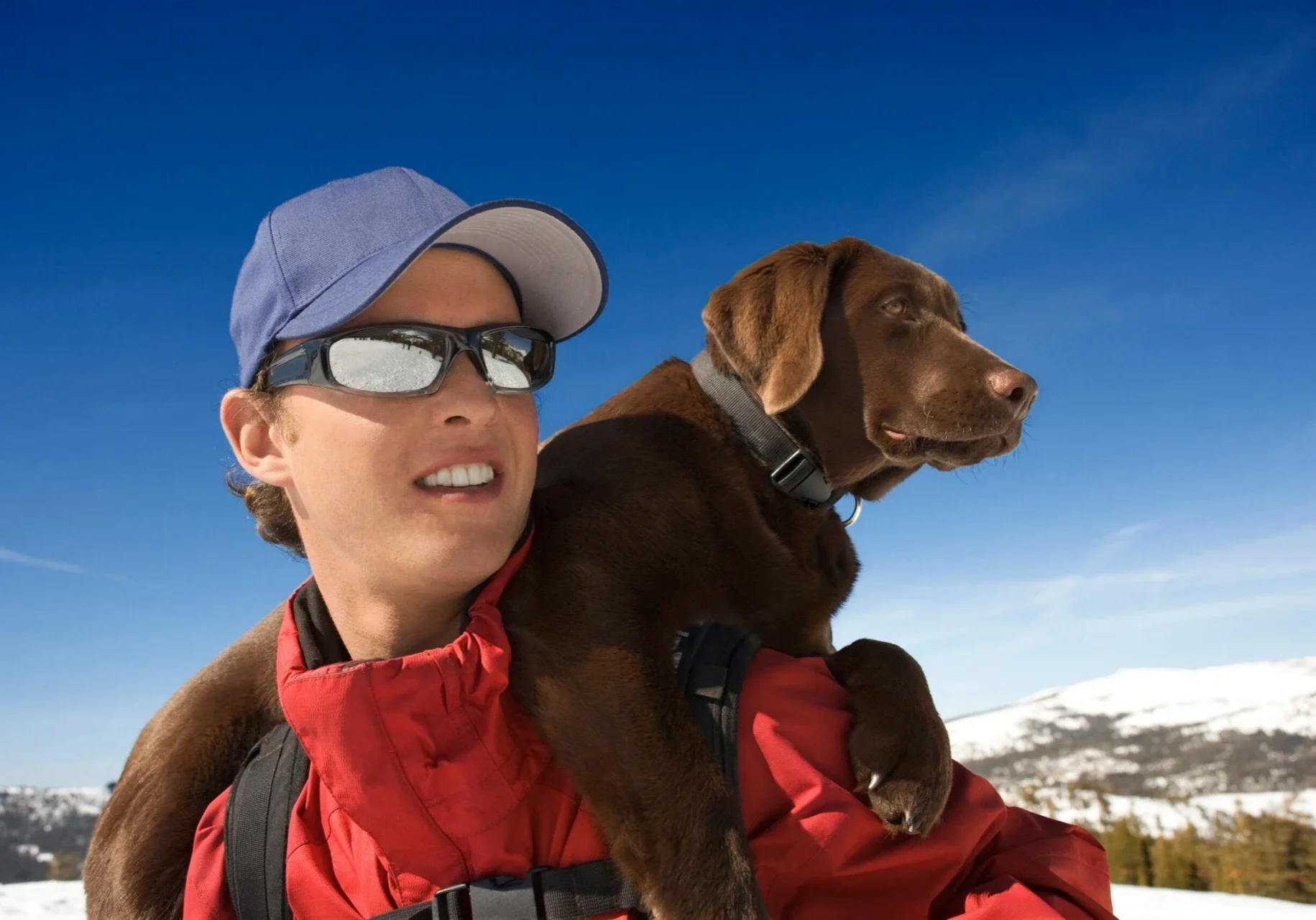 Hiker carrying dog on shoulders
